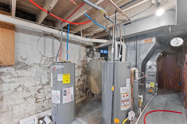 utility room featuring gas water heater and electric water heater