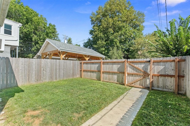 view of yard with a gate and a fenced backyard