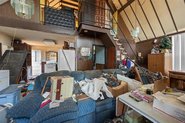 interior space with high vaulted ceiling and wood walls