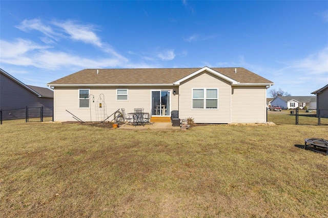 back of house with a lawn and a patio