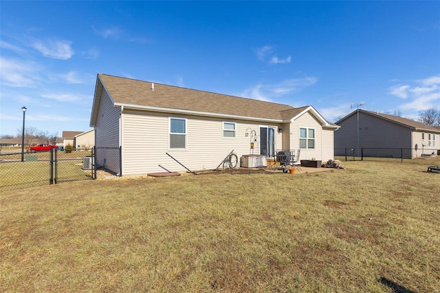 back of house featuring cooling unit and a yard