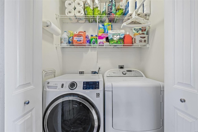 clothes washing area featuring independent washer and dryer