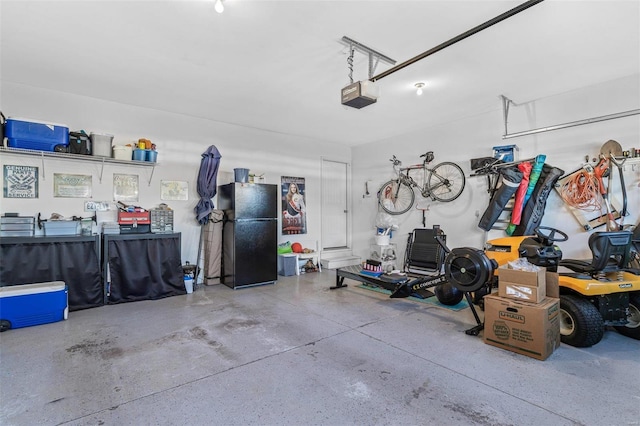 garage featuring black refrigerator and a garage door opener