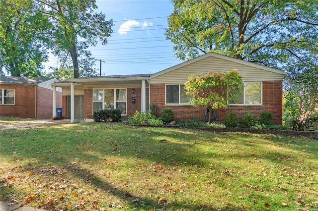 ranch-style home featuring a front lawn and a carport