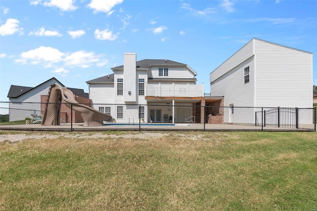 rear view of house with a yard