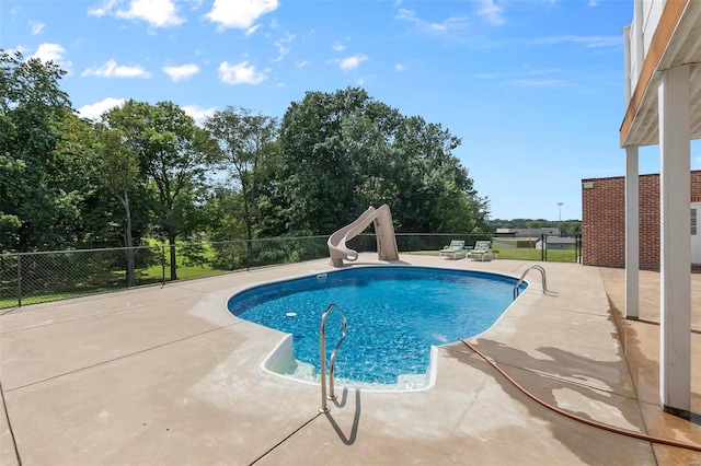 view of pool with a patio area and a water slide