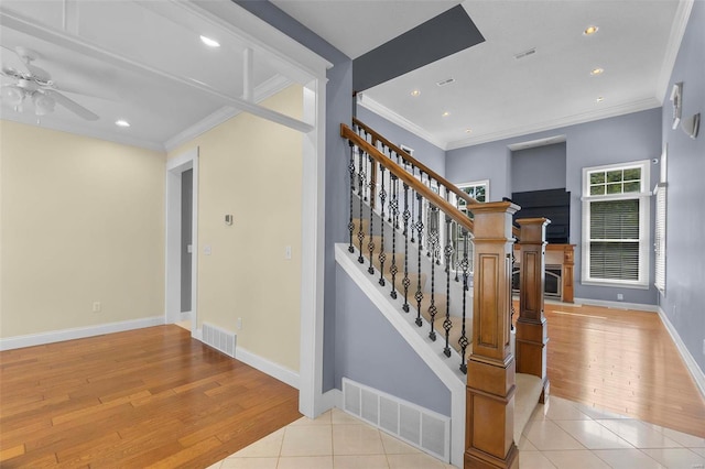 stairway featuring tile patterned flooring and ornamental molding