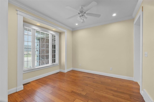 spare room featuring ornamental molding, light hardwood / wood-style floors, and a wealth of natural light