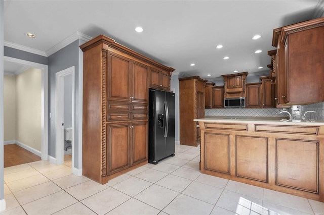 kitchen featuring tasteful backsplash, light tile patterned floors, crown molding, and black refrigerator with ice dispenser