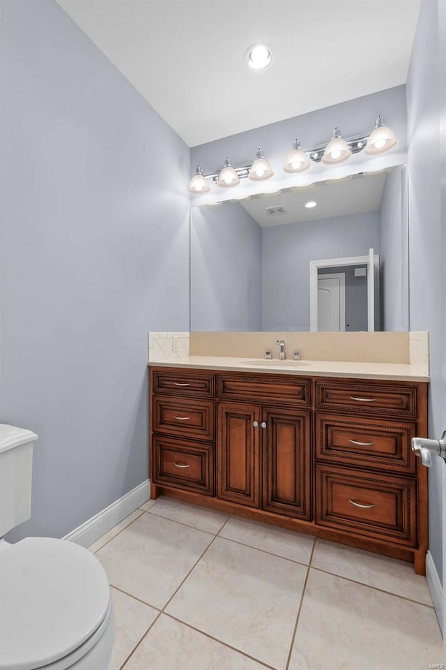 bathroom featuring vanity, toilet, and tile patterned flooring