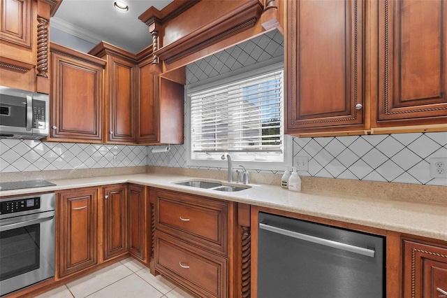 kitchen with appliances with stainless steel finishes, sink, backsplash, ornamental molding, and light tile patterned floors