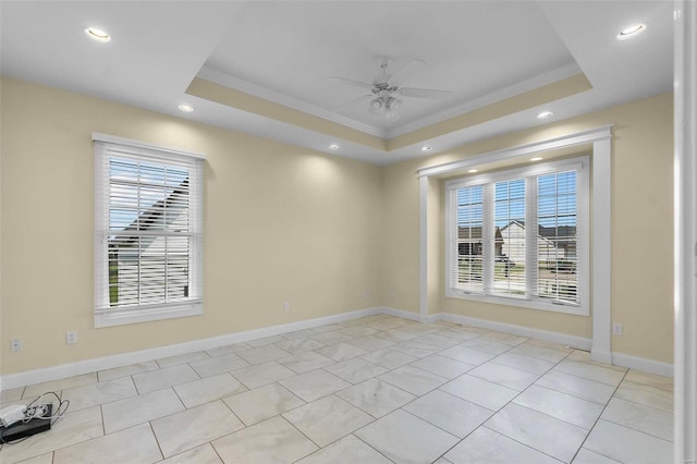 unfurnished room with crown molding, ceiling fan, and a tray ceiling