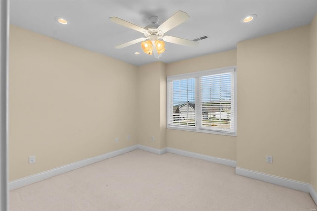 carpeted spare room featuring ceiling fan