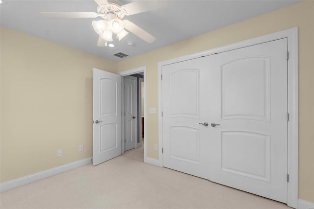 bedroom featuring light carpet, a closet, and ceiling fan