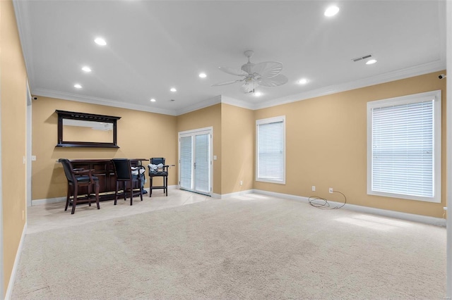 living room featuring crown molding, ceiling fan, and light carpet