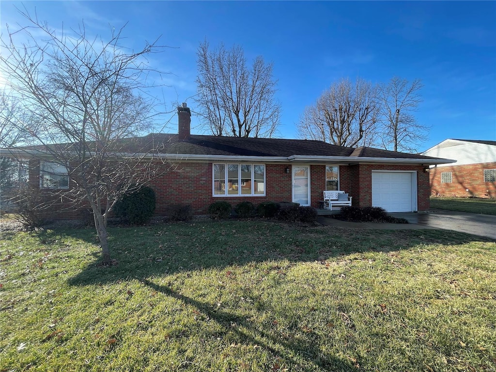 single story home featuring a garage and a front yard