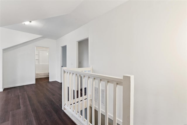 hall featuring baseboards and wood finished floors