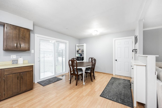 dining space featuring light wood-type flooring