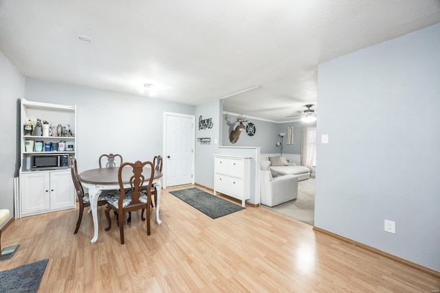 dining space featuring ceiling fan and light hardwood / wood-style flooring