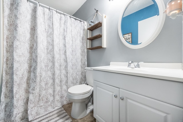 bathroom featuring tile patterned flooring, vanity, and toilet