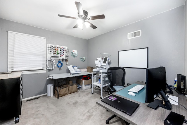 home office with light carpet and ceiling fan