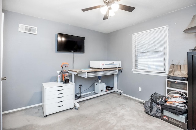 carpeted home office with ceiling fan