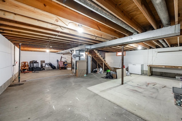 basement featuring heating unit and fridge