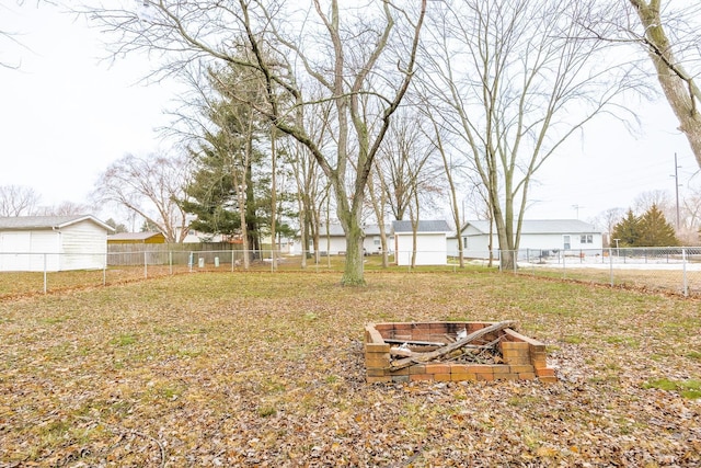 view of yard with a fire pit