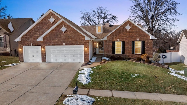 view of front of property featuring a garage and a yard