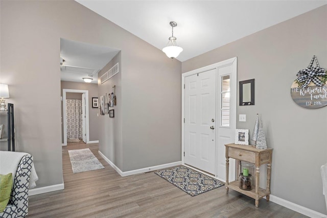 entrance foyer featuring lofted ceiling and hardwood / wood-style floors