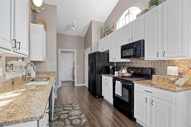 kitchen featuring white cabinetry, lofted ceiling, sink, and black appliances