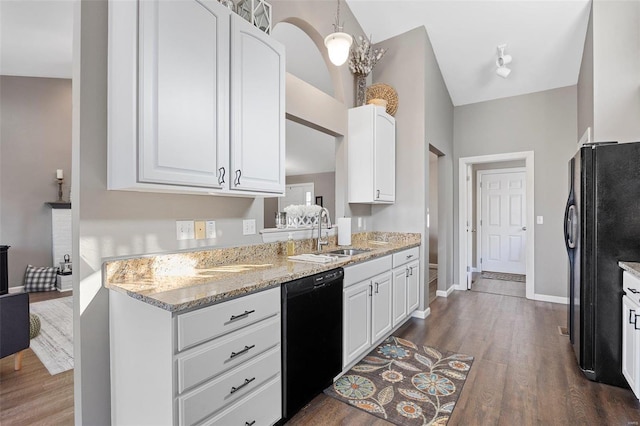 kitchen with sink, pendant lighting, white cabinets, and black appliances