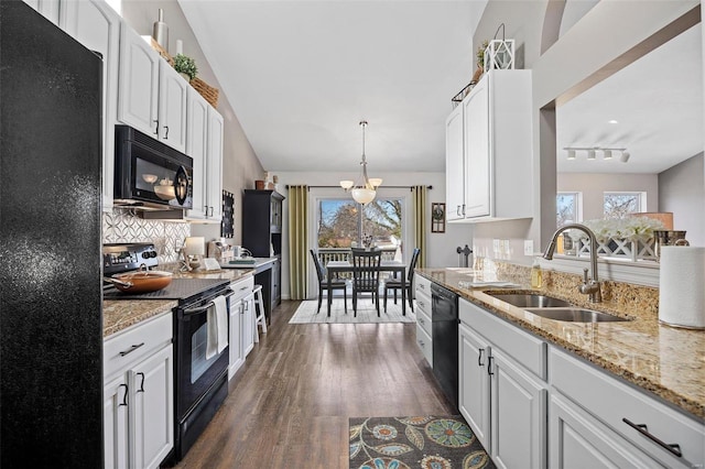 kitchen with sink, white cabinetry, black appliances, dark hardwood / wood-style flooring, and decorative light fixtures