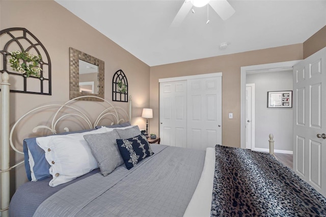 bedroom featuring wood-type flooring, lofted ceiling, ceiling fan, and a closet