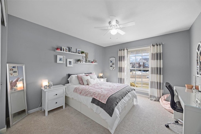 bedroom featuring ceiling fan and light carpet