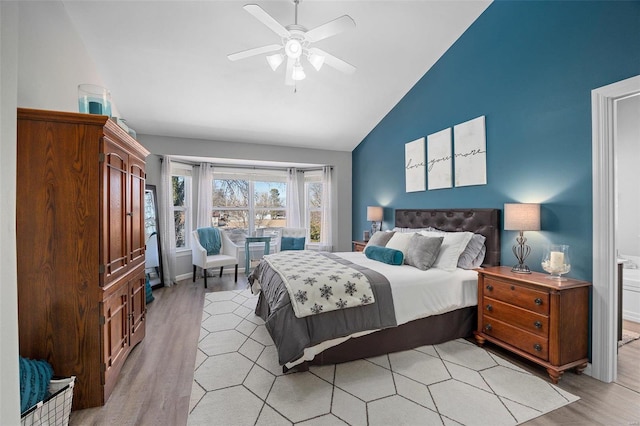 bedroom with vaulted ceiling, ceiling fan, and light wood-type flooring