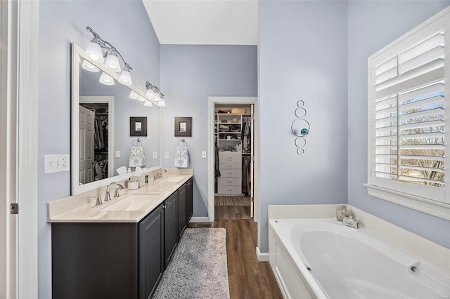 bathroom featuring vanity, a bathtub, and wood-type flooring