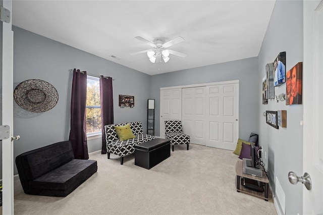 sitting room with carpet floors and ceiling fan