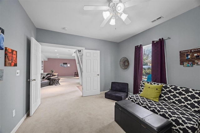 carpeted living room with ceiling fan