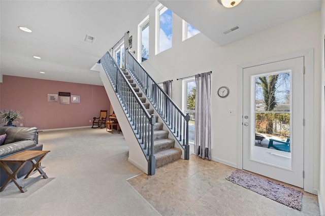 view of carpeted foyer entrance