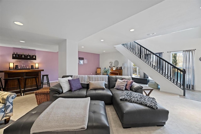 carpeted living room with bar