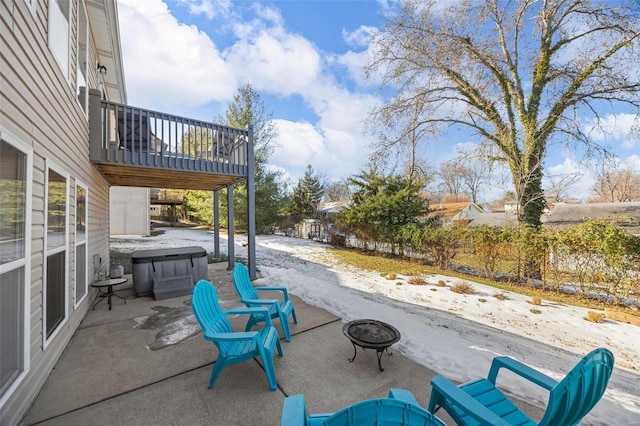 view of patio featuring a hot tub and an outdoor fire pit