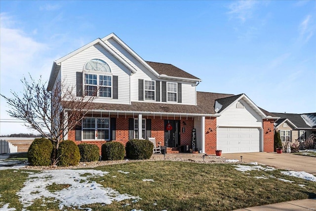 view of front of home with a garage, a porch, and a lawn