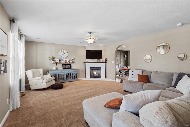 carpeted living room featuring ceiling fan