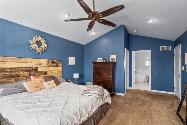 carpeted bedroom featuring ceiling fan, ensuite bathroom, and vaulted ceiling