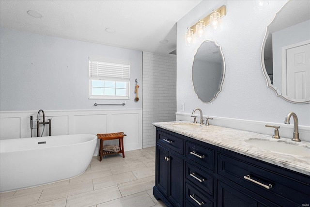 bathroom with tile patterned flooring, vanity, and a tub