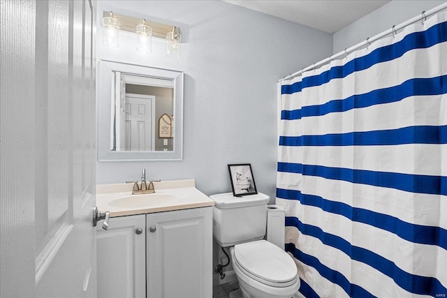 bathroom with vanity, toilet, a shower with shower curtain, and a textured ceiling