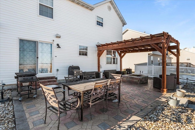 view of patio featuring area for grilling, a pergola, and a fire pit