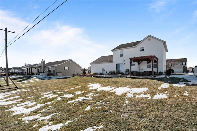 back of property with a gazebo and a lawn