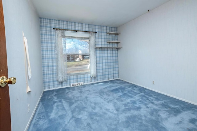 unfurnished room with dark carpet